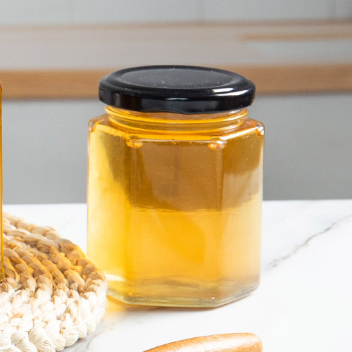 стаклена шестоугаона тегла за мед са поклопцем